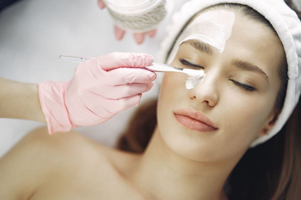 A treatment formulation being applied to the face during a resurfacing appointment.